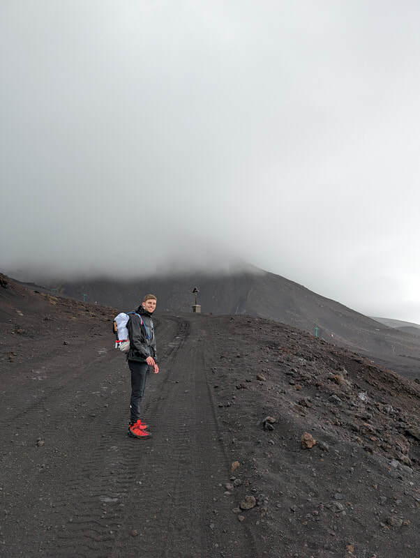 A walker on the barren volcano.