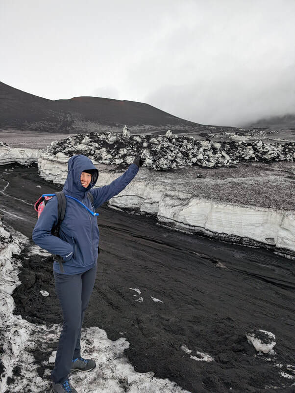 A walker pointing towards where Mount Etna would be if it wasn't so cloudy.