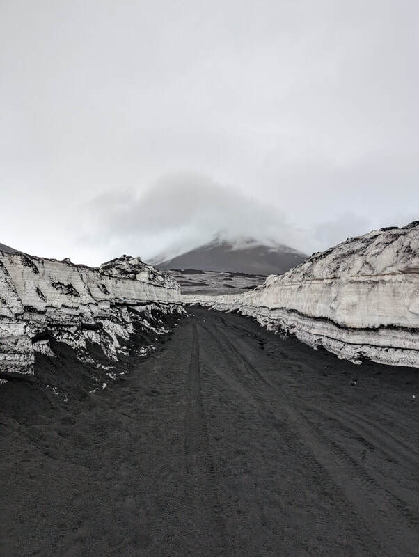 View of Mount Etna from between two walls of snow.