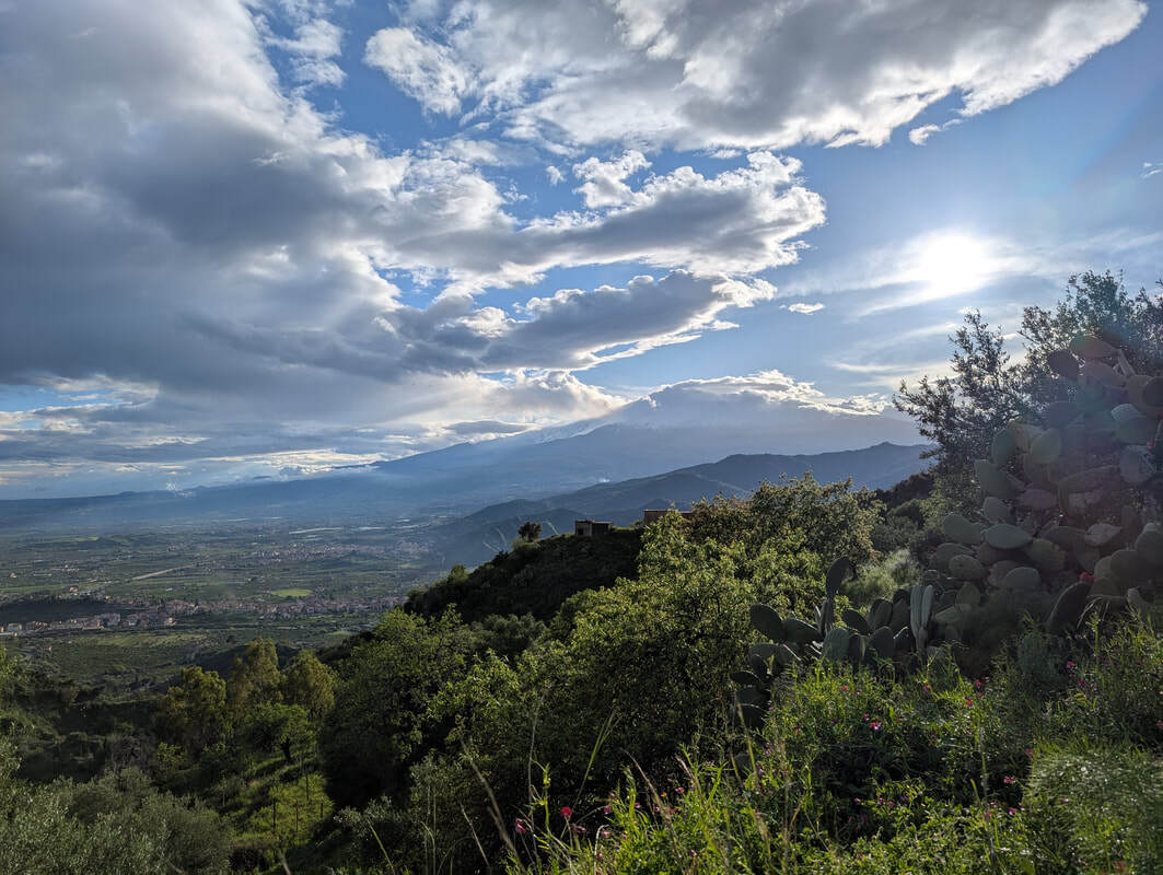 Mount Etna peaking out from beneath the clouds