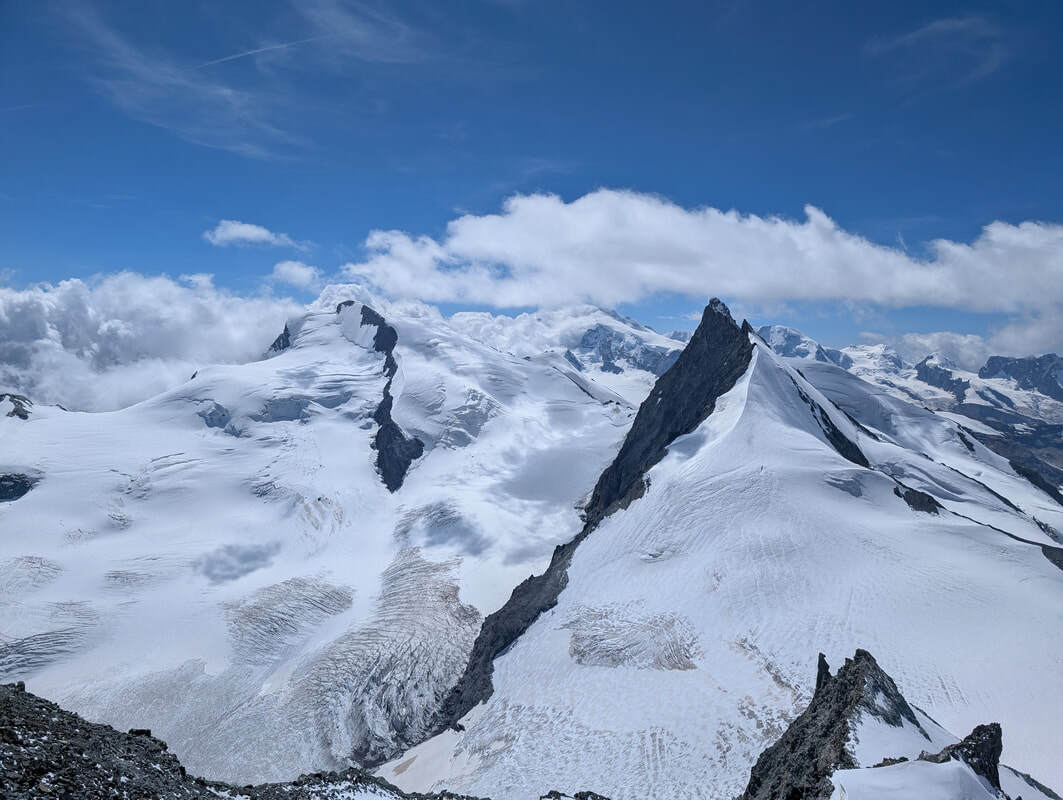 A view from the summit ridge towards Monte Rosa and Rimpfischorn.