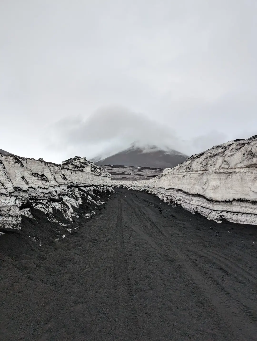 View of Mount Etna from between two walls of snow.