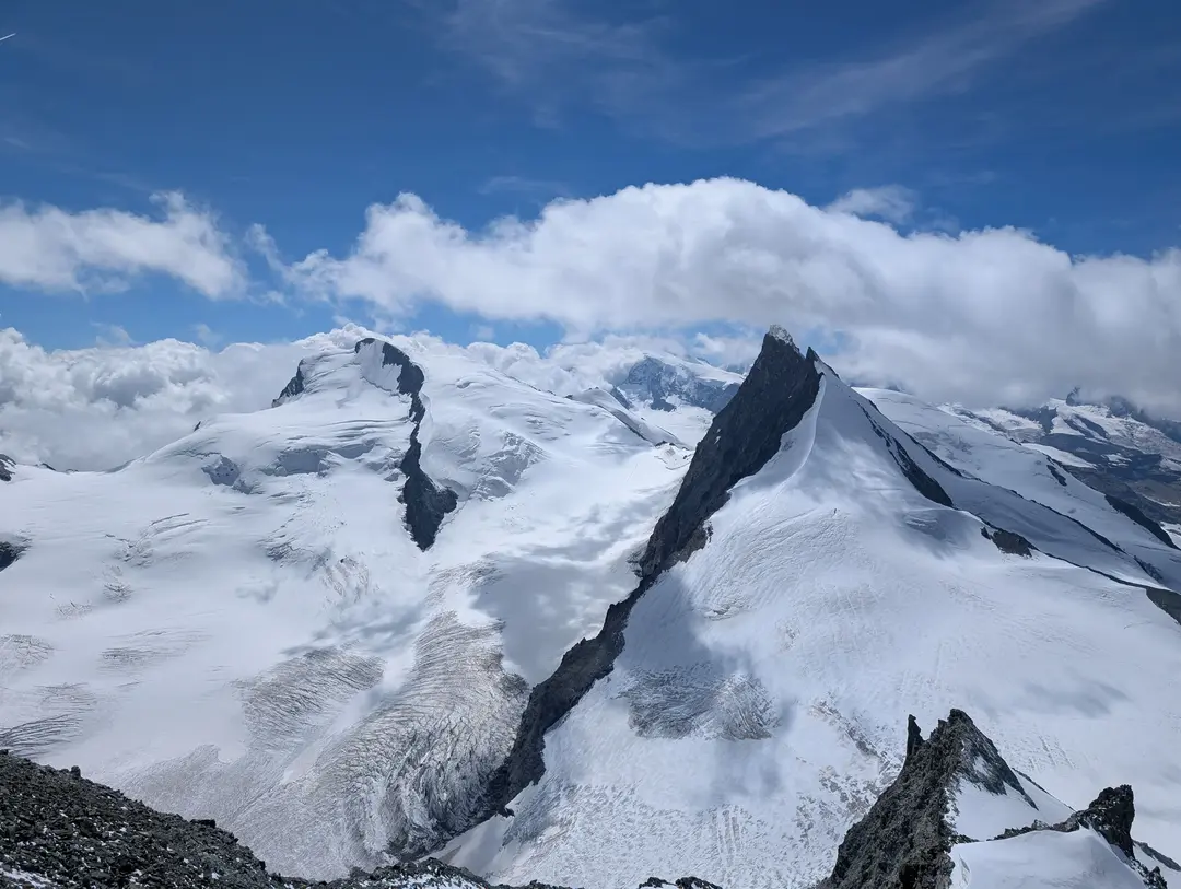 A view from the summit ridge towards Monte Rosa and Rimpfischorn.