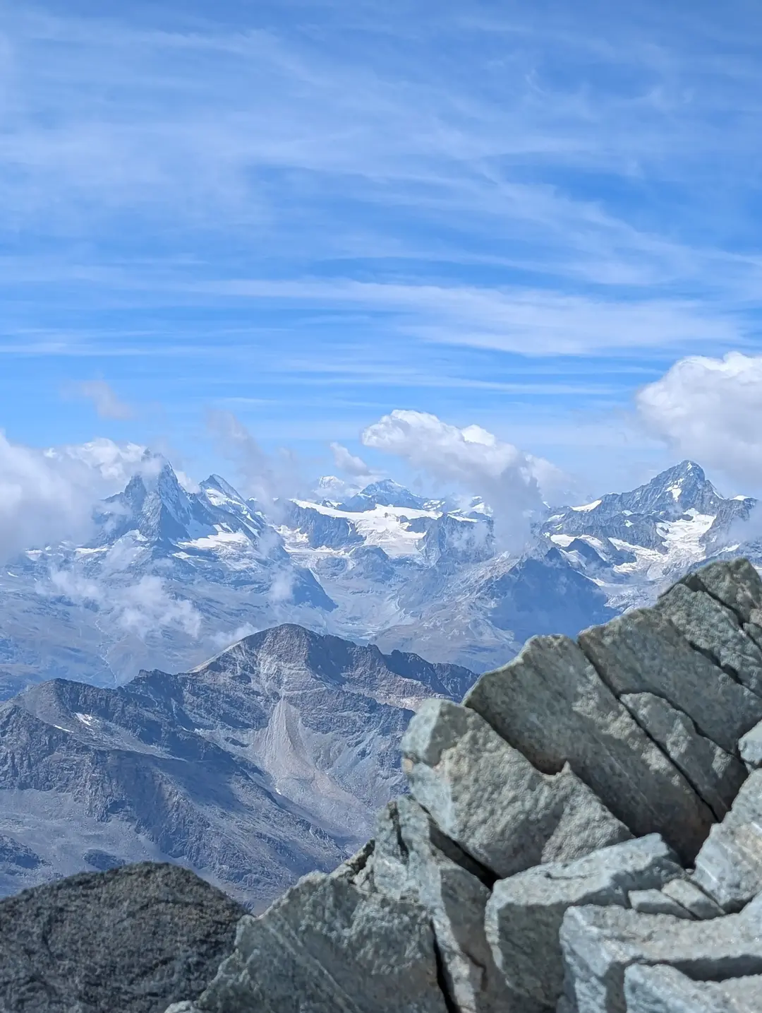 View from the summit with the Matterhorn and Mont Blanc obscured by clouds.